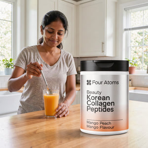 Four Atoms collagen powder mixed in a glass of water, mango peach flavour